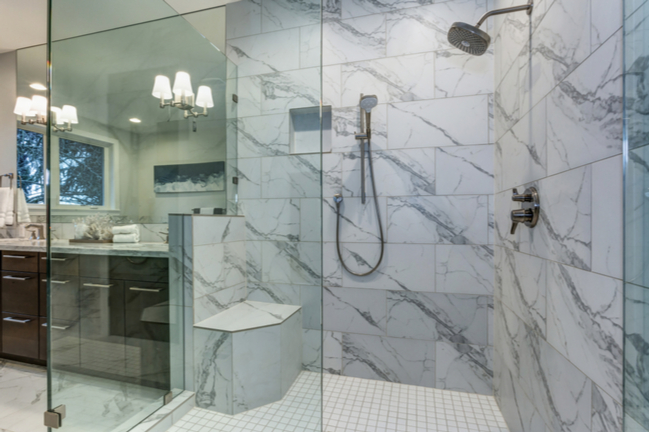 Shower enclosure showcases a shower bench, taking this large shower to the next level.