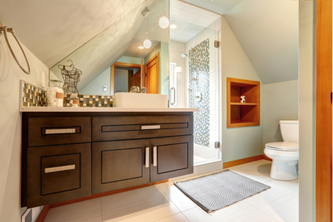 Bathroom utilizes an alcove to save space on the shower enclosure.